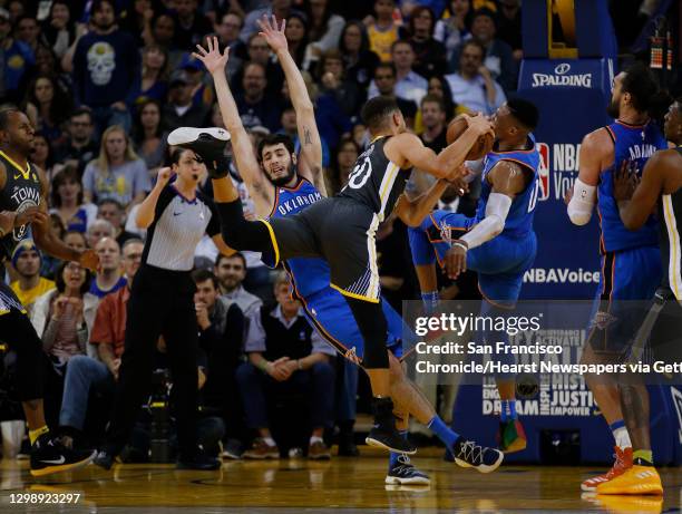 Golden State Warriors guard Stephen Curry is fouled during the second half of an NBA game between the Warriors and Oklahoma City Thunder at Oracle...