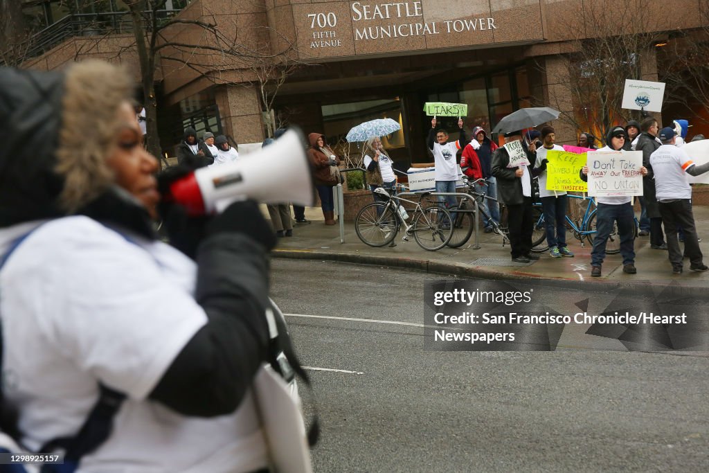 Uber and Lyft drivers protest outside of the Seattle Municipal Tower, Tuesday, as the city's law allowing drivers to decide if they want to bargain collectively goes into effect today. (Genna Martin, seattlepi.com)