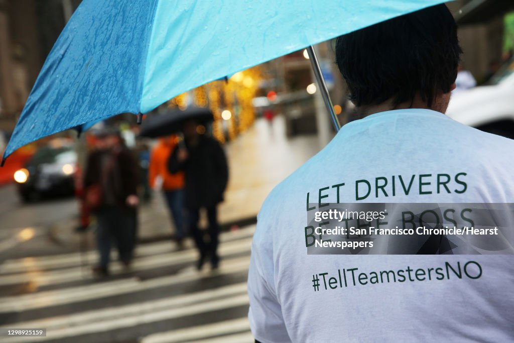 Uber and Lyft drivers protest outside of the Seattle Municipal Tower, Tuesday, as the city's law allowing drivers to decide if they want to bargain collectively goes into effect today. (Genna Martin, seattlepi.com)