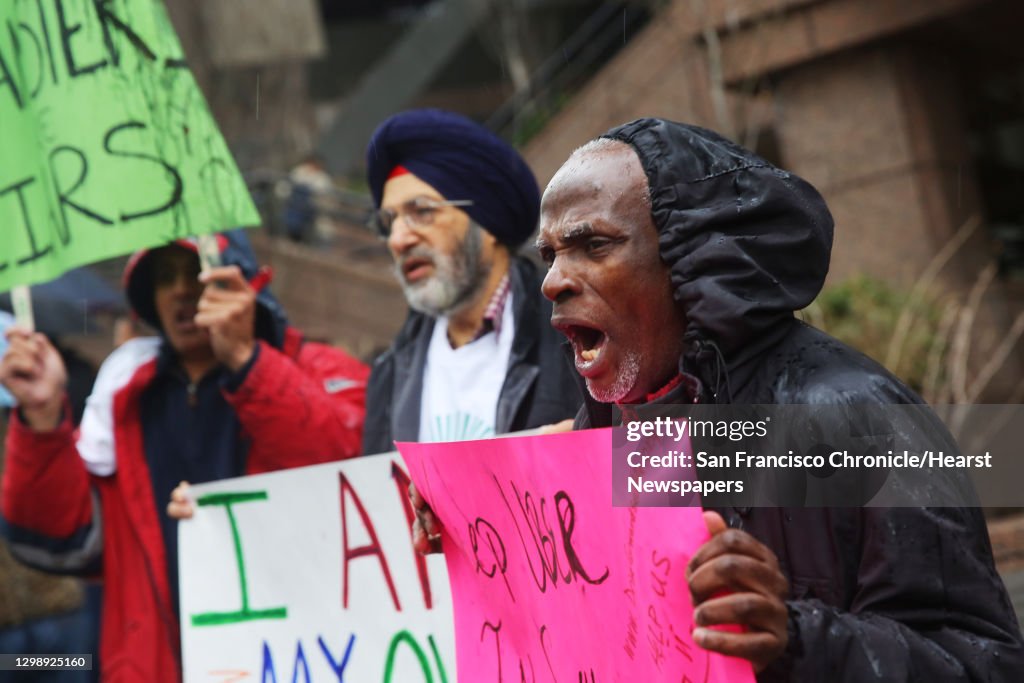 Uber and Lyft drivers protest outside of the Seattle Municipal Tower, Tuesday, as the city's law allowing drivers to decide if they want to bargain collectively goes into effect today. (Genna Martin, seattlepi.com)