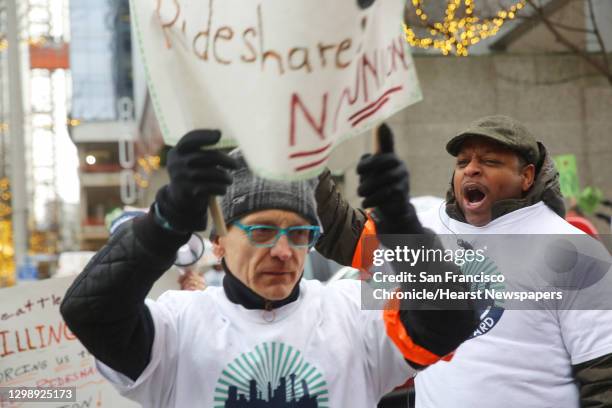 Charles Jenkins, right, and other Uber and Lyft drivers protest..., News Photo