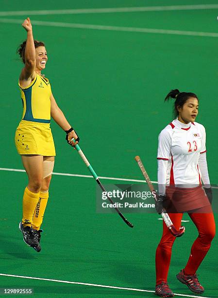 Kellie White of Australia celebrates a goal as Rabiatul Adawiyah Mohamed of Malaysia walks past during the match between Australia and India on day...