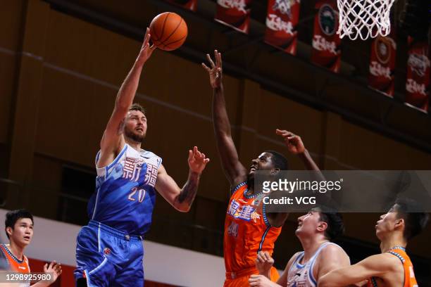 Donatas Motiejunas of Xinjiang Flying Tigers shoots the ball against Andrew Nicholson of Fujian Sturgeons during 2020/2021 Chinese Basketball...