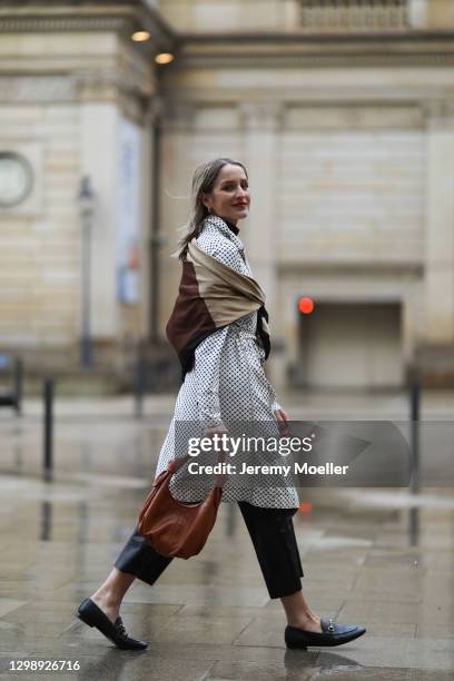 Louisa Theresa Grass wearing Marc Cain black and white coat, H&M scarf and pants, Anna Loch beige leather bag, Gucci loafer on January 26, 2021 in...