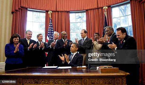 Hilda Solis, secretary of labor, from left, Douglas Oberhelman, chief executive officer of Caterpillar Inc., Thomas Vilsack, secretary of...