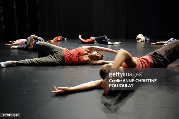 Dancers of the Geneva's Great Theatre warm up on October 21, 2011 at the Maison pour la danse "Klap" in Marseille, southern France. The venue will be...