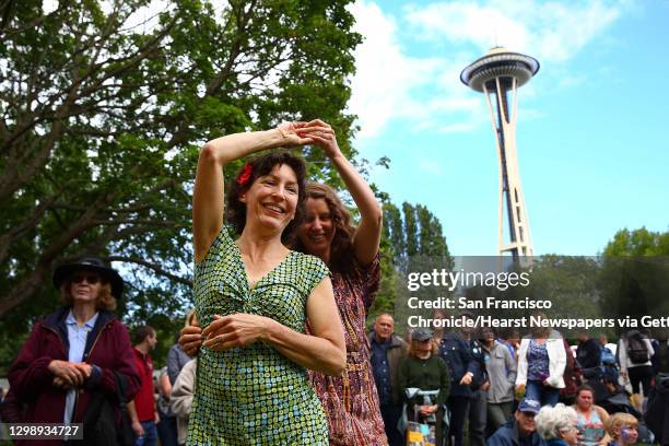 Margot Richardson and Julia Tobin dance to the music of Wylie and the Wild West during the 2016 Northwest Folklife Festival at Seattle Center, May...