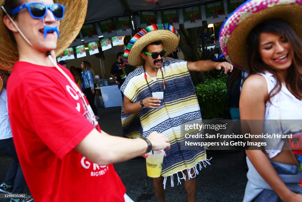 Rich Goodloe, left, Kenzo Kressbach, center, and Samantha Lee dance at the annual Cinco de Mayo block party hosted by the Green Lake Tacos Guaymas, March 5, 2016.  The party featured food, drinks, and various djs, bands and dance performances.  (Genna Mar