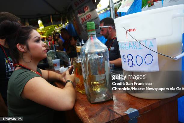 Woman waits for a margarita at the annual Cinco de Mayo block party hosted by the Green Lake Tacos Guaymas, March 5, 2016. The party featured food,...