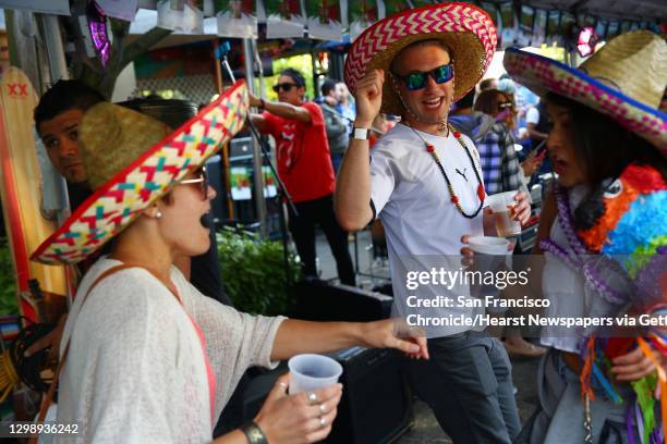 Karl Nachmann, center, and Kristina Pilat, left, dance at the annual Cinco de Mayo block party hosted by the Green Lake Tacos Guaymas, March 5, 2016....