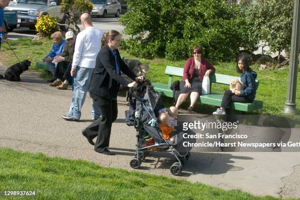 Duboce Park, Steiner st. San Francisco;Anne Conley, with twins Oliver and Lily walk past Marie Roark and Neennara Hirunkul. People and dogs sharing...
