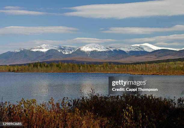 springtime view of the white mountains presidential range across cherry pond near jefferson, new hampshire usa - great pond (new hampshire) stock pictures, royalty-free photos & images