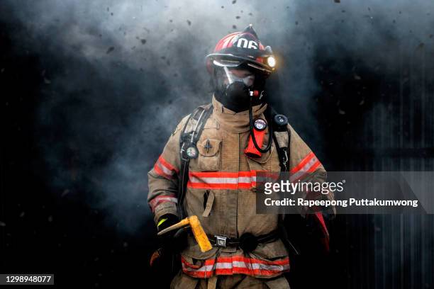 rescue man in firefighter uniform and oxygen mask. - fireman axe stock pictures, royalty-free photos & images