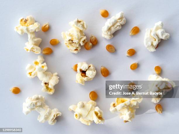 popcorn and seeds on a white background. - popcorn full frame stock pictures, royalty-free photos & images