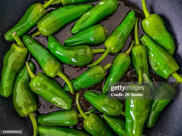 pimientos or mini peppers that fry in olive oil. - chili oil stock pictures, royalty-free photos & images
