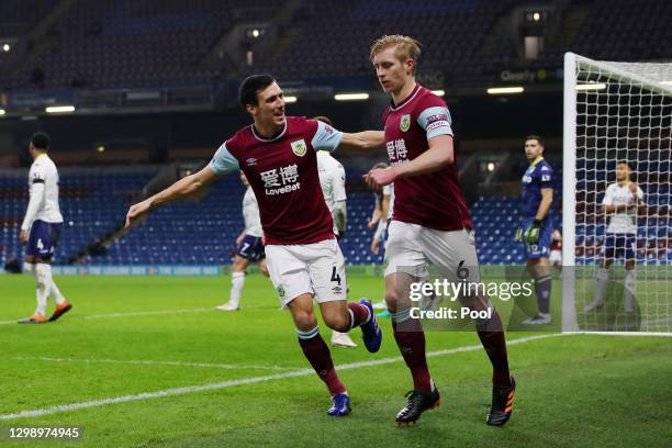 Ben Mee of Burnley celebrates after scoring their sides first goal with team mate Jack Cork during the Premier League match between Burnley and Aston...