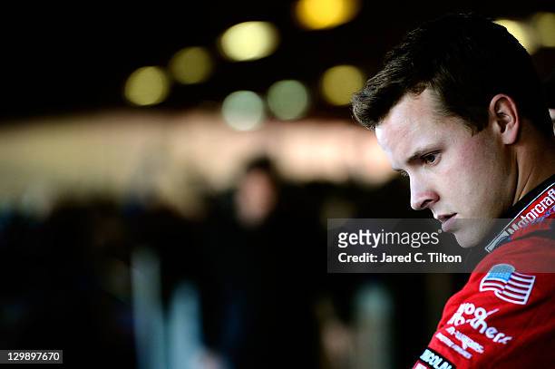 Trevor Bayne, driver of the Motorcraft/Quick Lane Tire & Auto Center Ford, stands in the garage area during practice for the NASCAR Sprint Cup Series...