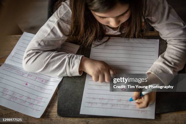 child writing letters to her friends - hand writing foto e immagini stock