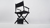 Back of black director chair and clapperboard.It is use in video production or movie and cinema industry on white background.