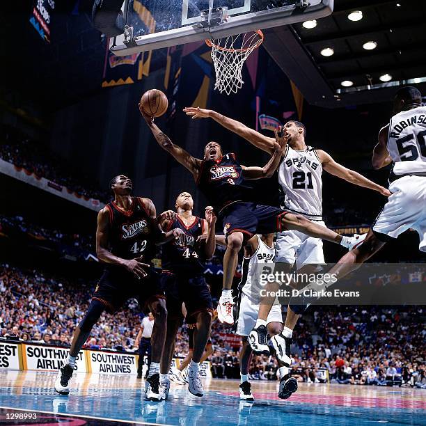 Allen Iverson of the Philadelphia 76ers drives to the basket against Tim Duncan of the San Antonio Spurs during an NBA game at the Alamo Dome in San...