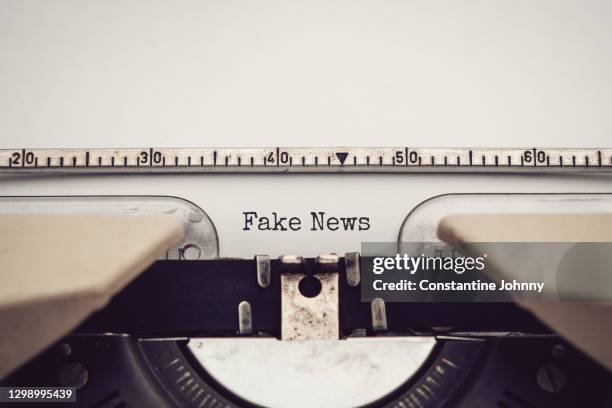 fake news. close up of typewriter close up view with text. - fake news stock-fotos und bilder