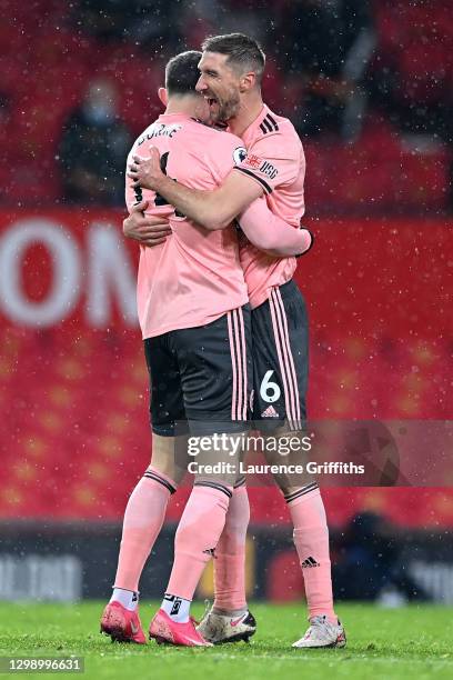 Oliver Burke of Sheffield United is congratulated by Chris Basham of Sheffield United after scoring their sides second goal during the Premier League...