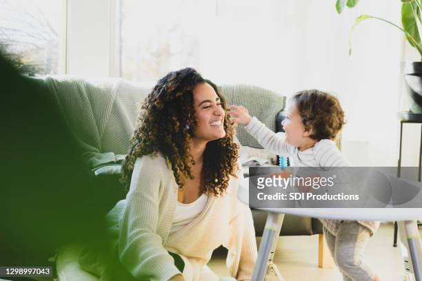 baby boy plays with his mother - nanny stock pictures, royalty-free photos & images