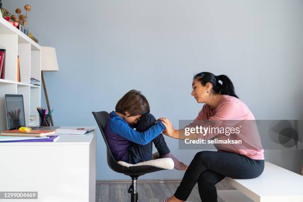mother talking to bored schoolboy having e-learning - unhappy school child stock pictures, royalty-free photos & images