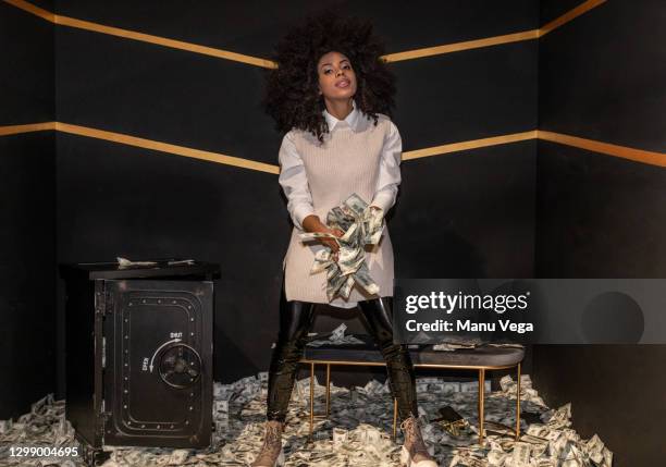 afro woman holding money bills on her hands. - throwing money stock pictures, royalty-free photos & images