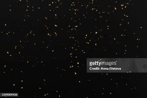 holiday glittering background with falling little dusting particles of confetti on black. birthday party or celebrating new year and christmas holidays - glitter black background stockfoto's en -beelden