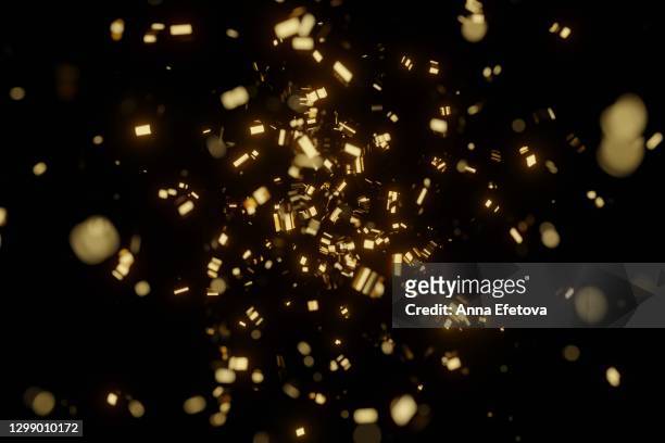 holiday glittering background with falling golden foil confetti on black background. birthday party or celebrating new year and christmas holidays - silvester party stock-fotos und bilder