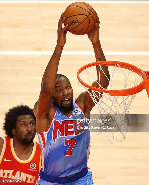 Kevin Durant of the Brooklyn Nets dunks against Solomon Hill of the Atlanta Hawks during the first half at State Farm Arena on January 27, 2021 in...