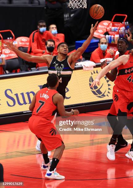 Giannis Antetokounmpo of the Milwaukee Bucks shoots over Kyle Lowry of the Toronto Raptors during a game at Amalie Arena on January 27, 2021 in...