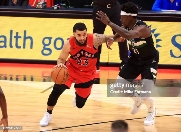 Fred VanVleet of the Toronto Raptors drives on Jrue Holiday of the Milwaukee Bucks during a game at Amalie Arena on January 27, 2021 in Tampa,...