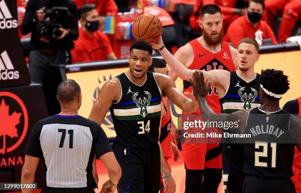 Giannis Antetokounmpo of the Milwaukee Bucks reacts to a play during a game against the Toronto Raptors at Amalie Arena on January 27, 2021 in Tampa,...