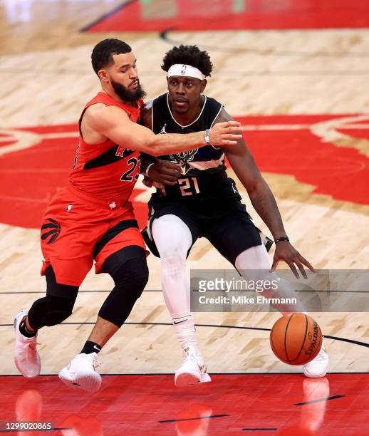 Jrue Holiday of the Milwaukee Bucks drives on Fred VanVleet of the Toronto Raptors during a game at Amalie Arena on January 27, 2021 in Tampa,...