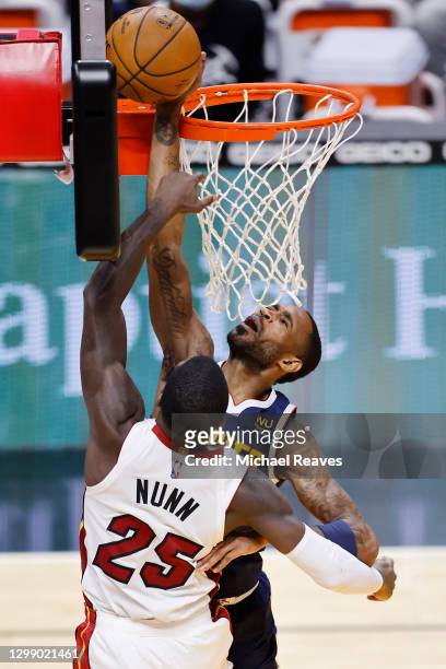 Monte Morris of the Denver Nuggets blocks a dunk by Kendrick Nunn of the Miami Heat during the third quarter at American Airlines Arena on January...
