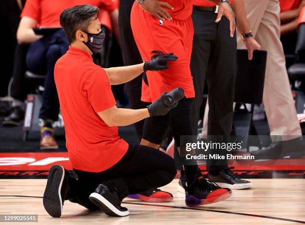 Norman Powell of the Toronto Raptors is worked on by a trainer with a Hyperice Hypervolt massage tool during a game against the Milwaukee Bucks at...