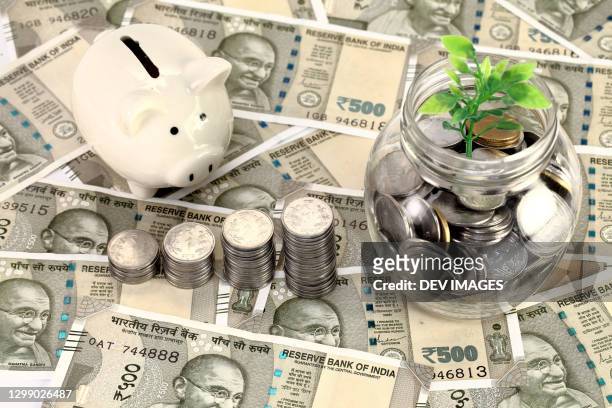 concept of money savings-piggy bank and indian currency - rupee stock pictures, royalty-free photos & images