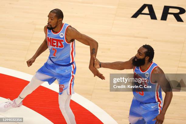 James Harden and Kevin Durant of the Brooklyn Nets react during overtime against the Atlanta Hawks at State Farm Arena on January 27, 2021 in...