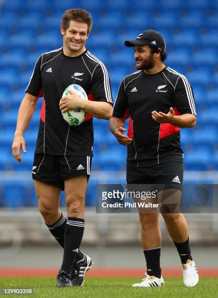 Richie McCaw and Piri Weepu of the All Blacks chat during a New Zealand All Blacks captain's run at Trusts Stadium on October 22, 2011 in Auckland,...