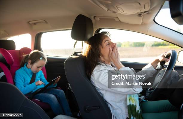 tired mother with child in car - tired driver stock pictures, royalty-free photos & images