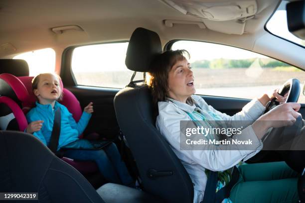 mother and daugter singing in car - daughter driving stock pictures, royalty-free photos & images