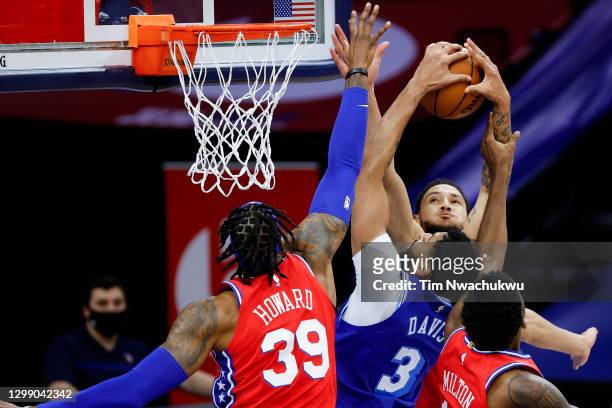 Anthony Davis of the Los Angeles Lakers is guarded by Ben Simmons, Dwight Howard, and Shake Milton of the Philadelphia 76ers during the fourth...