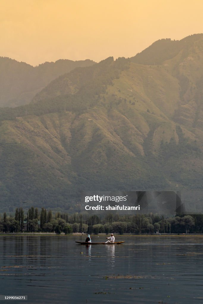 Sightseeing over Dal Lake using a shikara - a type of wooden boat. Shikara are of varied sizes and are used for multiple purposes, including transportation of people.