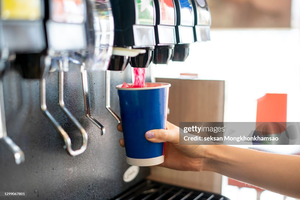 Man pours a fizzy drink.sparkling water.cool ice soft drink cola