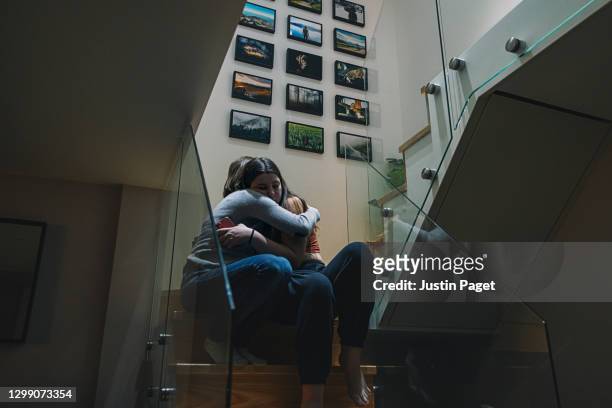 woman comforting her upset teenage daughter - grief support stock pictures, royalty-free photos & images