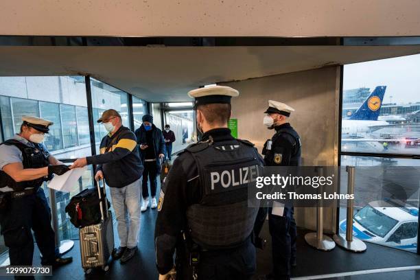 Border police check passengers arriving on a flight from Spain to be sure they can show evidence of a recent COVID-19 test at Frankfurt Airport...