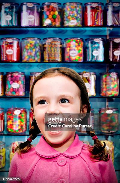 girl in a candy store - excited kids stock-fotos und bilder