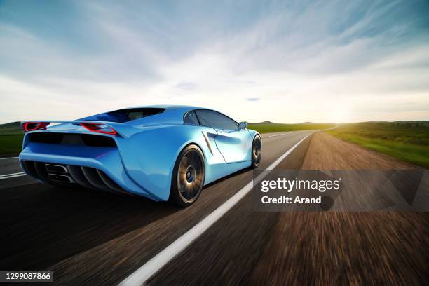 blue sportscar driving on a road - carro desportivo imagens e fotografias de stock